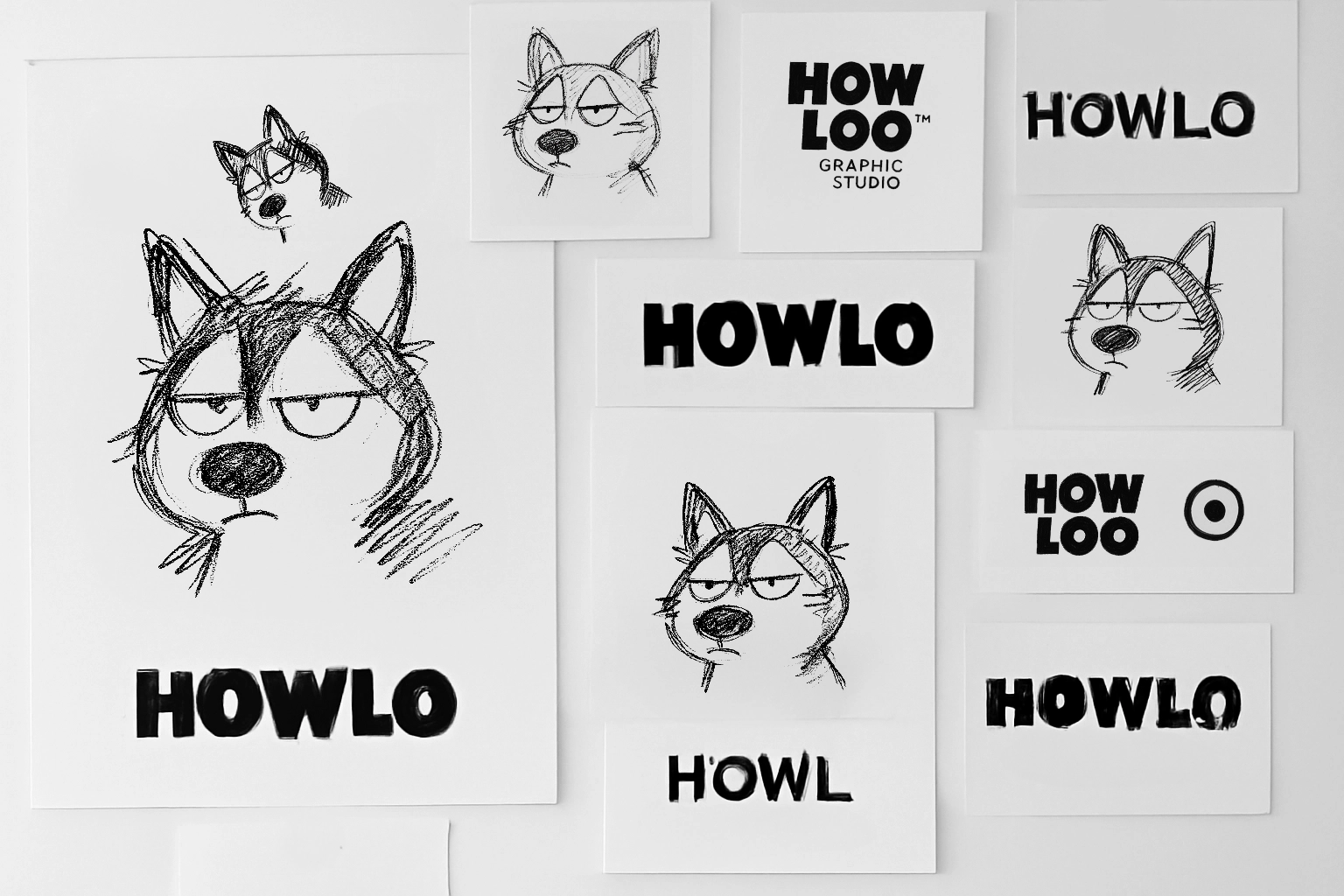 Planche de croquis pour recherche du logo HOWLO studio. Husky dessiné avec une expression blasée. Typographie épaisse et massive.